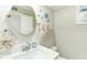 Bright bathroom with a modern vanity, decorative turtle art, and a round mirror at 4362 Wesley Ln, North Port, FL 34287