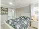Cozy bedroom with light walls and decor, a ceiling fan, and a door leading to the ensuite bathroom at 4362 Wesley Ln, North Port, FL 34287