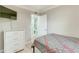 Guest bedroom with light wood floors, a gray plaid comforter, and a dresser at 4362 Wesley Ln, North Port, FL 34287