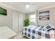 Bright bedroom with natural light, a ceiling fan, and a closet for storage at 4362 Wesley Ln, North Port, FL 34287