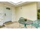 Cozy front porch featuring a cute table set and a welcoming front door at 4362 Wesley Ln, North Port, FL 34287