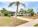 Charming single-story home with a well-maintained lawn, mature palms and ample driveway parking at 4362 Wesley Ln, North Port, FL 34287