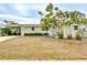 Charming single-story home featuring mature palm trees, and a covered carport at 4362 Wesley Ln, North Port, FL 34287