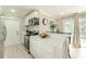 Open kitchen with stainless steel appliances, white cabinets, and breakfast bar overlooking the pool at 4362 Wesley Ln, North Port, FL 34287