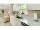 Well-lit kitchen features white countertops, stainless steel sink, and a convenient coffee station at 4362 Wesley Ln, North Port, FL 34287