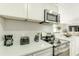 Bright kitchen features stainless steel appliances, white cabinetry, and light countertops at 4362 Wesley Ln, North Port, FL 34287