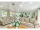 Spacious living room boasts hardwood floors, white ceilings, and an open view into the kitchen at 4362 Wesley Ln, North Port, FL 34287