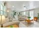 Bright and airy living room with hardwood floors, white ceilings, and view of the outdoor pool at 4362 Wesley Ln, North Port, FL 34287
