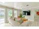 Cozy living room with a large TV, comfortable seating, and sliding doors to the outdoor area at 4362 Wesley Ln, North Port, FL 34287