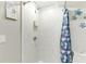 Marble tiled shower with glass door, toiletries, and decorative shower curtain at 4362 Wesley Ln, North Port, FL 34287
