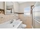 Bathroom boasts tiled walls and flooring, featuring a well-lit vanity, toilet and shower at 4820 8Th S Ave, St Petersburg, FL 33711