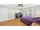 Bedroom features hardwood floors, a purple bedspread, and a dedicated computer setup by the window at 4820 8Th S Ave, St Petersburg, FL 33711