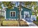Charming teal bungalow with a quaint front porch and landscaped walkway at 4820 8Th S Ave, St Petersburg, FL 33711