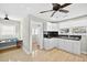 Bright kitchen showcases tile flooring, white cabinets, and a pass-through to adjacent space with desk at 4820 8Th S Ave, St Petersburg, FL 33711