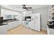 Well-lit kitchen with tile floors, white appliances, and black countertop offers a functional design at 4820 8Th S Ave, St Petersburg, FL 33711