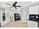 View of kitchen featuring tile flooring, white cabinetry and black countertop with a pass-through to dining room at 4820 8Th S Ave, St Petersburg, FL 33711