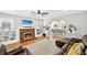 Cozy living room with a fireplace and open view to the dining area at 4820 8Th S Ave, St Petersburg, FL 33711