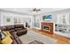 Warm living room featuring a cozy fireplace and comfortable seating area at 4820 8Th S Ave, St Petersburg, FL 33711