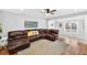 Open-concept living room with hardwood floors and large sectional sofa at 4820 8Th S Ave, St Petersburg, FL 33711