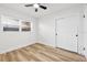 Empty bedroom with wood floors, a window, and a closet with sliding doors at 523 Deville E Dr, Largo, FL 33771