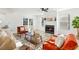 Inviting living room featuring a fireplace, contemporary decor, wood floors, and French doors at 523 Deville E Dr, Largo, FL 33771
