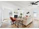 Cozy living room featuring a modern fireplace, sleek furniture, hardwood floors, and bright lighting at 523 Deville E Dr, Largo, FL 33771