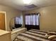 Bedroom featuring neutral colored walls, a round mirror and patterned bedding at 5901 N 34Th St, Tampa, FL 33610
