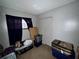 Simple bedroom featuring a single window with dark curtains and closet doors at 5901 N 34Th St, Tampa, FL 33610