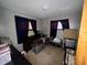 Cluttered bedroom with a small window and dark curtains, showcasing the room's storage and size at 5901 N 34Th St, Tampa, FL 33610
