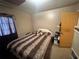Cozy bedroom with a neutral color scheme, side table and standard closet at 5901 N 34Th St, Tampa, FL 33610