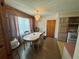 Cozy dining area featuring an elegant chandelier and adjacent access to the kitchen at 5901 N 34Th St, Tampa, FL 33610