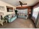 Inviting living room with comfortable sofas, a ceiling fan, and natural light from the window at 5901 N 34Th St, Tampa, FL 33610