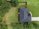 Aerial view of the property, highlighting the roof, landscaping, and expansive backyard at 6103 Fairway Dr, Ridge Manor, FL 33523