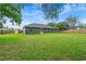 Spacious backyard featuring a well-maintained lawn and a wooden fence for privacy at 6103 Fairway Dr, Ridge Manor, FL 33523