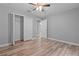 Nicely finished bedroom with ceiling fan, wood-look floors, and closet at 6103 Fairway Dr, Ridge Manor, FL 33523