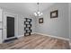Dining room with modern decor, wood-look floors, and a door to the outside at 6103 Fairway Dr, Ridge Manor, FL 33523