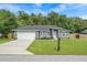 Charming home featuring an inviting lawn and an attached two-car garage at 6103 Fairway Dr, Ridge Manor, FL 33523