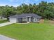 Charming single-story home with a well-manicured lawn, inviting curb appeal, and an attached two-car garage at 6103 Fairway Dr, Ridge Manor, FL 33523
