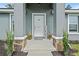 Inviting front porch with decorative plants and charming decor, creating a welcoming entrance at 6103 Fairway Dr, Ridge Manor, FL 33523
