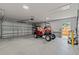 Spacious garage featuring a golf cart, storage space, and durable flooring for versatile use at 6103 Fairway Dr, Ridge Manor, FL 33523
