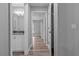 Hallway view with wood-look floors leading to the bathroom and other rooms at 6103 Fairway Dr, Ridge Manor, FL 33523
