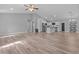 Open-concept living room with modern flooring and ample natural light, perfect for entertaining at 6103 Fairway Dr, Ridge Manor, FL 33523