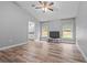 Open living room with views to the bathroom, and three windows at 6103 Fairway Dr, Ridge Manor, FL 33523