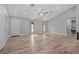 Bright, spacious living area featuring wood-look floors and an open layout at 6103 Fairway Dr, Ridge Manor, FL 33523