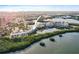 Panoramic aerial shot showcases the condo building nestled in a picturesque waterfront setting with lush greenery at 6450 Shoreline Dr Dr # 9202, St Petersburg, FL 33708