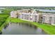 Aerial view of lakefront condo buildings with well-maintained lawns and serene water views at 6450 Shoreline Dr Dr # 9202, St Petersburg, FL 33708