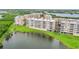 Scenic aerial view showcases the building with its lush surroundings, pond, and well-maintained landscaping at 6450 Shoreline Dr Dr # 9202, St Petersburg, FL 33708
