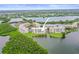 Aerial view of condo building surrounded by lush greenery, landscaping, and a picturesque waterfront at 6450 Shoreline Dr Dr # 9202, St Petersburg, FL 33708