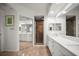 Bathroom featuring double sinks with a quartz countertop, mirrored closet doors, and a glass enclosed shower at 6450 Shoreline Dr Dr # 9202, St Petersburg, FL 33708