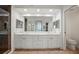 Bright bathroom with double sinks, white cabinets, quartz countertop, and a glass shower at 6450 Shoreline Dr Dr # 9202, St Petersburg, FL 33708